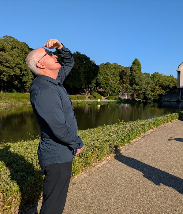 Dr Ballard looking at a balloon for observation in the sky above Daisen Park